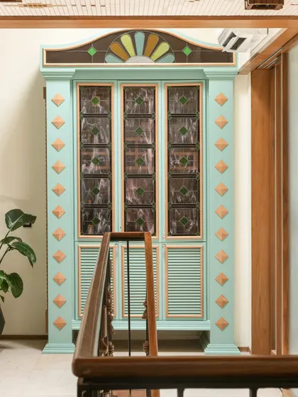 A close-up of the custom bar cabinet, a whimsical and functional piece of art that anchors the upper landing.