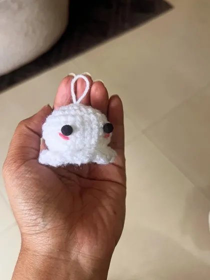 Holding a tiny white octopus charm in my hand. It’s amazing how much personality can be packed into such a small creation.