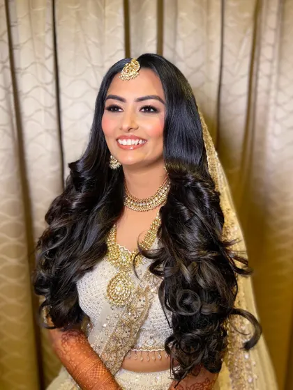 Bansi was a vision of grace in her white and gold wedding lehenga. I created a soft glam look with warm, shimmery eyes and a glossy nude lip to complement her angelic outfit.