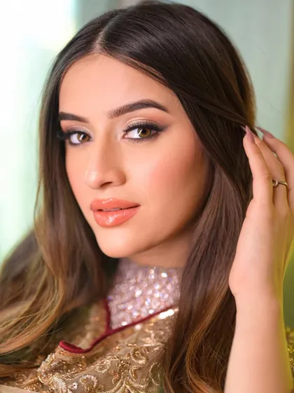A close-up of this soft, traditional makeup look. The eyes are subtly defined, the skin is glowing, and the lips have a beautiful, natural tint.