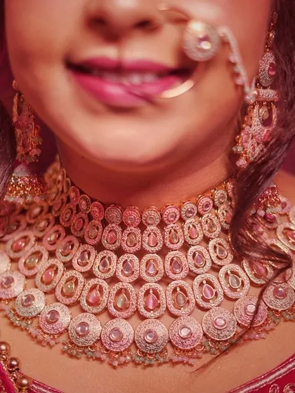 A beautiful, happy smile from the bride, with a focus on her gorgeous wedding necklace and nath.