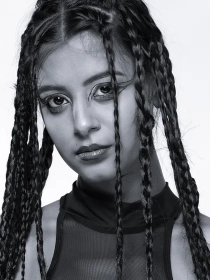 An intense black and white close-up, focusing on the model's direct gaze.