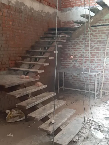 Another angle of the duplex staircase under construction, showing how it connects the different levels of the home.