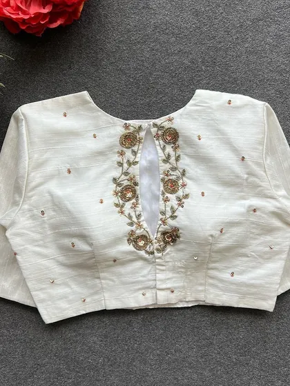 A full view of the back of the white handwork blouse.