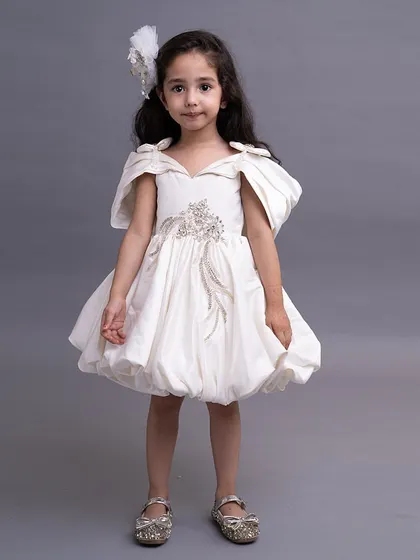 A sweet and simple white bubble dress with off shoulder details and a touch of embroidery.