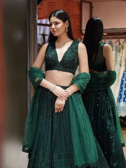 Dazzle in this bottle green sequin lehenga. The rich hue and intricate embellishments make it a go-to for a stunning, unforgettable look.