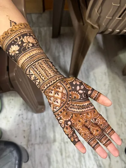 A non-bridal design featuring a beautiful lotus band on the forearm. This shows how traditional elements can be used in a more contemporary, minimalist way.