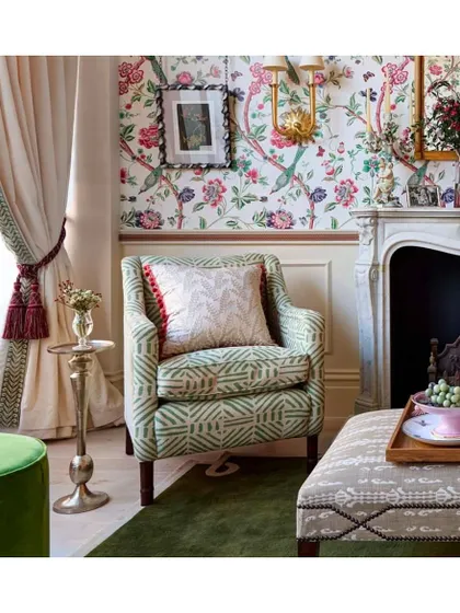 This space exudes retro, whimsical vibes with the Jardin de Bagatelle wallpaper from La Maison Pierre Frey. The playful pattern of birds and florals, combined with eclectic furniture, creates a room that is full of personality and charm.