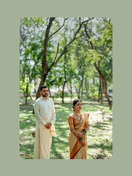 A serene portrait of the couple standing in a peaceful green space, a moment of calm amidst the wedding celebrations.
