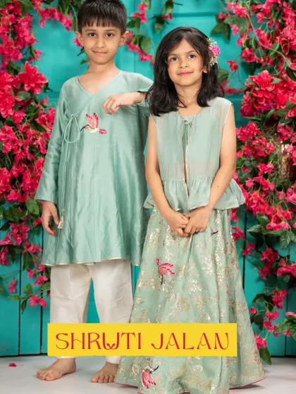 This mint green sibling set is perfect for summer celebrations. The breathable fabric keeps them comfortable, while the matching bird embroidery on his kurta and her lehenga creates a beautifully coordinated look.