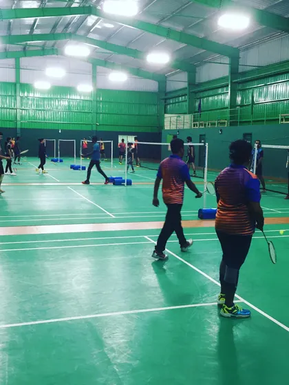 Players walking on the BWF-approved court surface between matches. The professional setup helps make your corporate event feel like a premier sporting occasion.