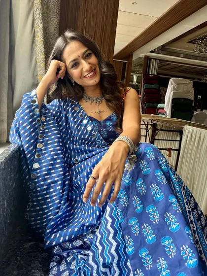 Relaxing before the Garba night begins. This shot showcases her radiant skin and the subtle details of her festive makeup.
