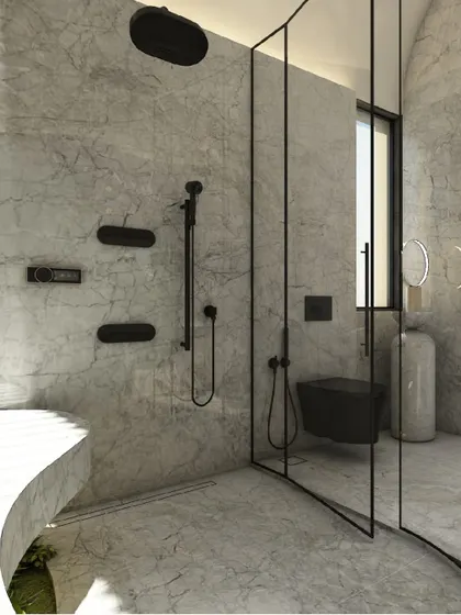 The walk-in shower area features sleek, minimalist black fixtures that stand in sharp contrast to the soft grey marble. The curved glass partition maintains the room's sense of fluidity and openness.