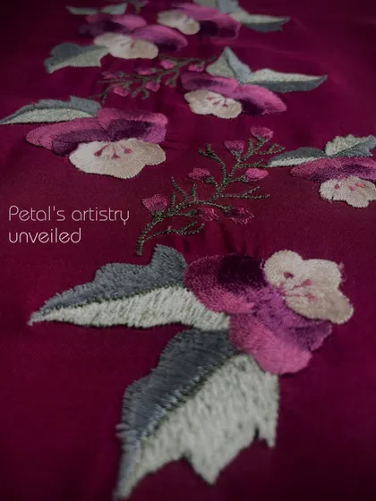 Petal's artistry unveiled. This embroidery of pansies showcases how each stitch pays tribute to the subtle beauty of nature.