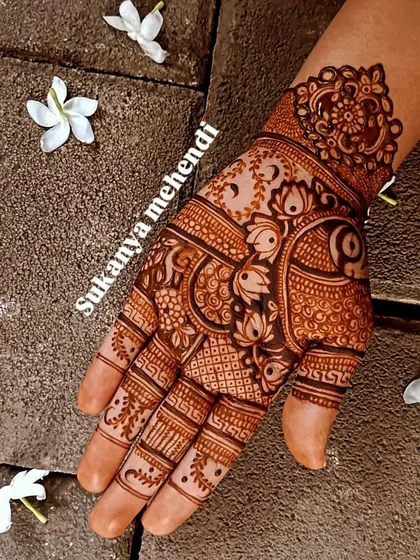 A classic design perfect for Karvachauth or any festive occasion. The combination of peacock and lotus motifs with intricate check patterns always looks stunning.