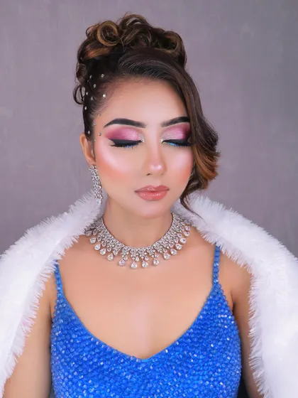 A close-up on the eyes, highlighting the beautiful blend of pink and blue shadows and the flawless base.