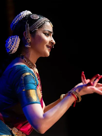 A close-up from the Kanasu festival, capturing a moment of storytelling through hand gestures and facial expression.