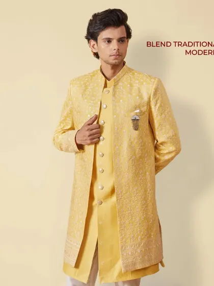 East meets West in this layered yellow Indo-Western outfit. The embroidered jacket over a matching kurta is a perfect way to blend traditional with modern style.