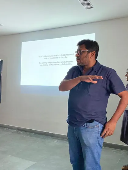 A student presents their design proposal during a design charette at CARE School of Architecture. These intensive workshops are designed to stimulate creative thinking and rapid problem solving.