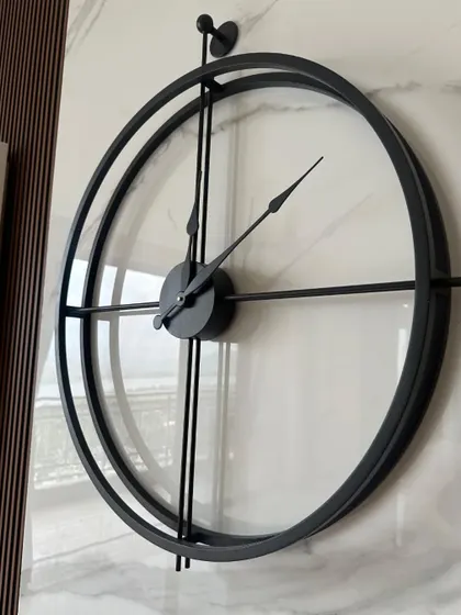 This angle shows the slim profile and clean construction of our minimalist double-ring wall clock. The antique black finish gives it a subtle, sophisticated texture that looks great against a marble or textured wall.