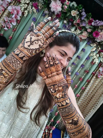 Another playful shot of the bride and her intricate story mehndi. The design is filled with details that are personal to her.