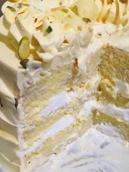 The best part of the Rasmalai cake is the inside. Here you can see the layers of soft, saffron-infused sponge and creamy rasmalai filling. It's an indulgent treat that combines the best of both worlds.