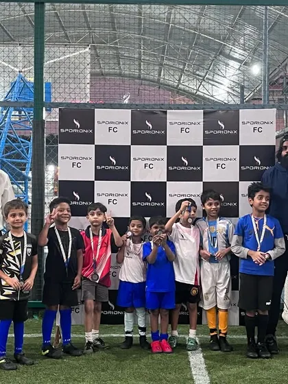 The prize distribution for our in-house football tournament, with young players receiving their medals.