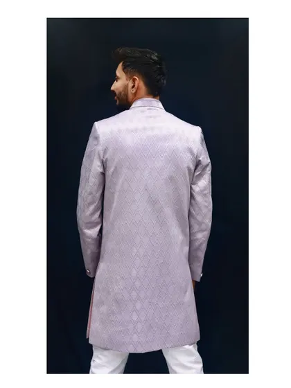 A view from the back of the lavender Indo-western. This angle shows the clean lines and perfect fit of the garment, highlighting the quality of the tailoring and the continuous pattern of the fabric.