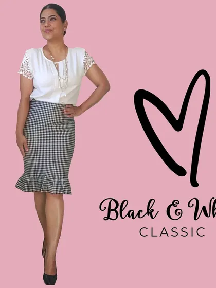 You can never go wrong with a classic black and white combination. This look pairs a simple white top with a black and white checked trumpet skirt for a timeless and elegant outfit.