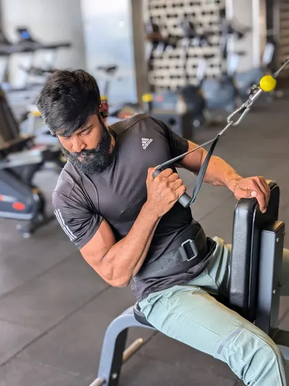 "Beard mode: On." A seated machine curl, perfect for isolating the bicep and ensuring strict form.