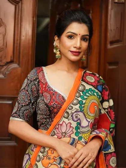 This look features a stunning Kalamkari saree with a bold, multi-colored print. The intricate design and vibrant palette make it a perfect choice for festive occasions.