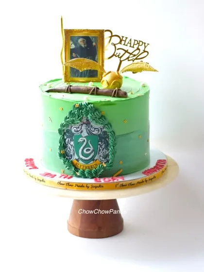 For the Harry Potter fans, I made this Slytherin house themed cake. It's a vanilla cake with green buttercream, the Slytherin crest, and a golden snitch topper.