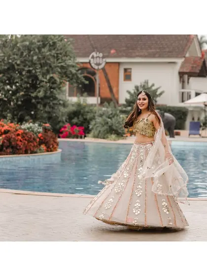 A joyful twirl from the bride by the pool at her Goa Haldi ceremony.