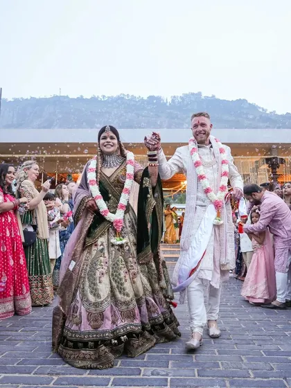 The couple's grand exit after the ceremony. Sonam and Ross walk hand-in-hand through a path of cheering family and friends, a joyful start to their new life together.