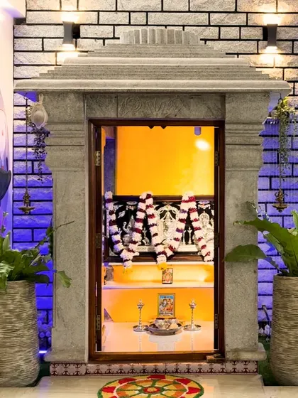 A dedicated space for peace and prayer. This unique pooja unit, crafted from traditional stone, stands as a spiritual centerpiece, blending seamlessly with the home's modern aesthetic while honoring timeless traditions.