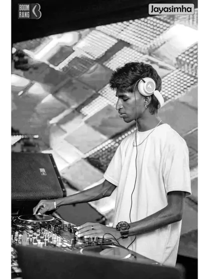 A black and white version that highlights the focus and form of a DJ at work, stripping away the color to show the raw action.