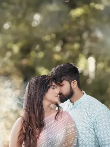 A dreamy and romantic portrait using a smoke bomb to create a soft, ethereal haze around the couple. The smoke adds a touch of magic and beautiful texture to the image.