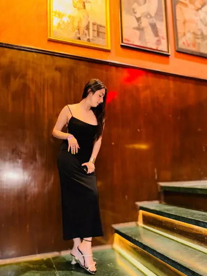 A different angle of the black gown, showing its simple elegance and timeless appeal.