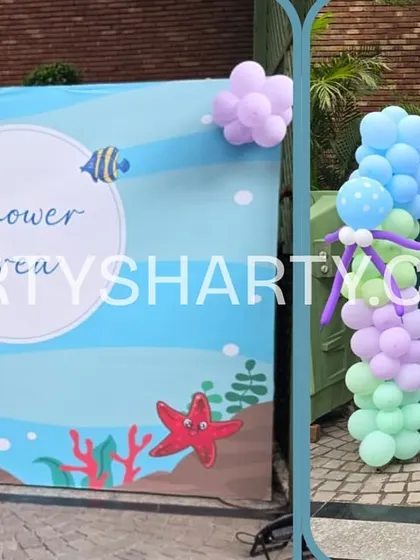 An outdoor photo area with an underwater backdrop and a fun 'Feed the Croc' game board, showing how we integrate activities into our decor.