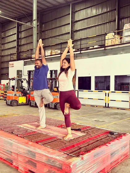 Leading the session from a makeshift stage of pallets. It's a reminder that you can create a sacred space for yoga anywhere, with anyone.