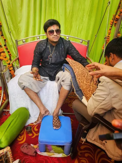 The groom relaxing during his mehndi ceremony. We ensure the entire process is comfortable, even when applying detailed designs to the feet.