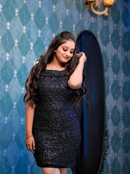 A duplicate of image 64, showing a chic and stylish party look. I created a smoky eye and styled her hair with loose waves to match this sparkling black dress.