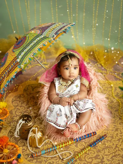 A full view of the vibrant Navratri setup, with rich fabrics, festive props, and a beautifully dressed baby girl ready to celebrate.