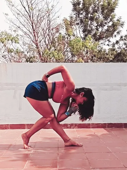 This creative standing pose, 'Ready Set Let Me Think', is a deep twist and hip opener. It challenges balance and flexibility, requiring you to find your center while folding into a compact shape.
