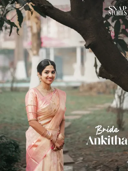 A classic portrait of the bride in her elegant light pink saree, set in a lovely garden. We use natural surroundings to enhance our portrait photography.
