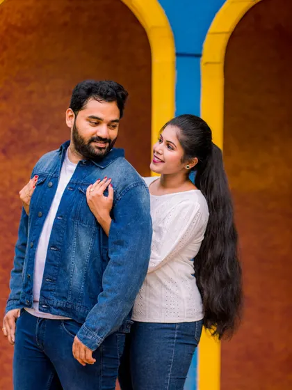 A candid, playful moment between a couple in casual denim outfits. I love capturing these unscripted interactions that show a couple's true connection.