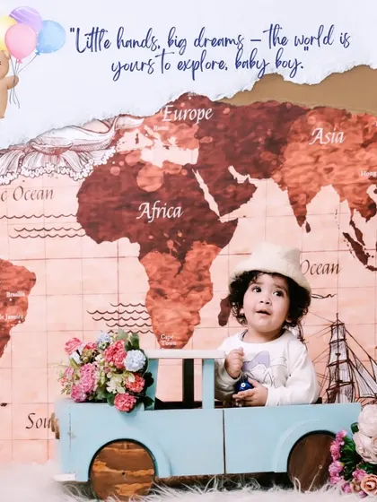 Little hands, big dreams. This creative travel-themed first birthday shoot features a world map backdrop and a cute wooden car prop.