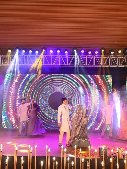 A beautifully coordinated family performance where traditional outfits meet modern stagecraft. The use of a dynamic LED backdrop and synchronized movements creates a visually stunning effect.