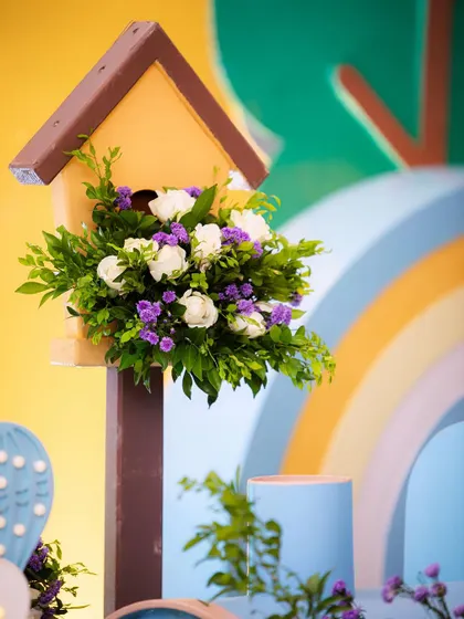 Another charming birdhouse detail, filled with white and purple flowers. These small touches are placed throughout the venue to create a cohesive look.