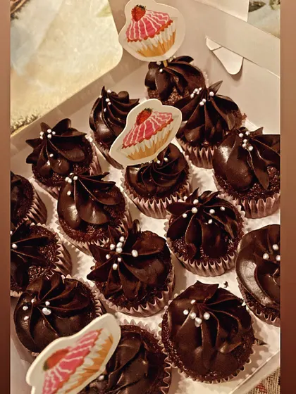 A box of my mini moist chocolate truffle cupcakes, ready to go. They are topped with a smooth ganache and delicate white pearls.